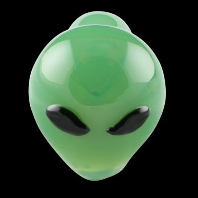 front view of a green glass pipe with the face of an Alien on the bowl